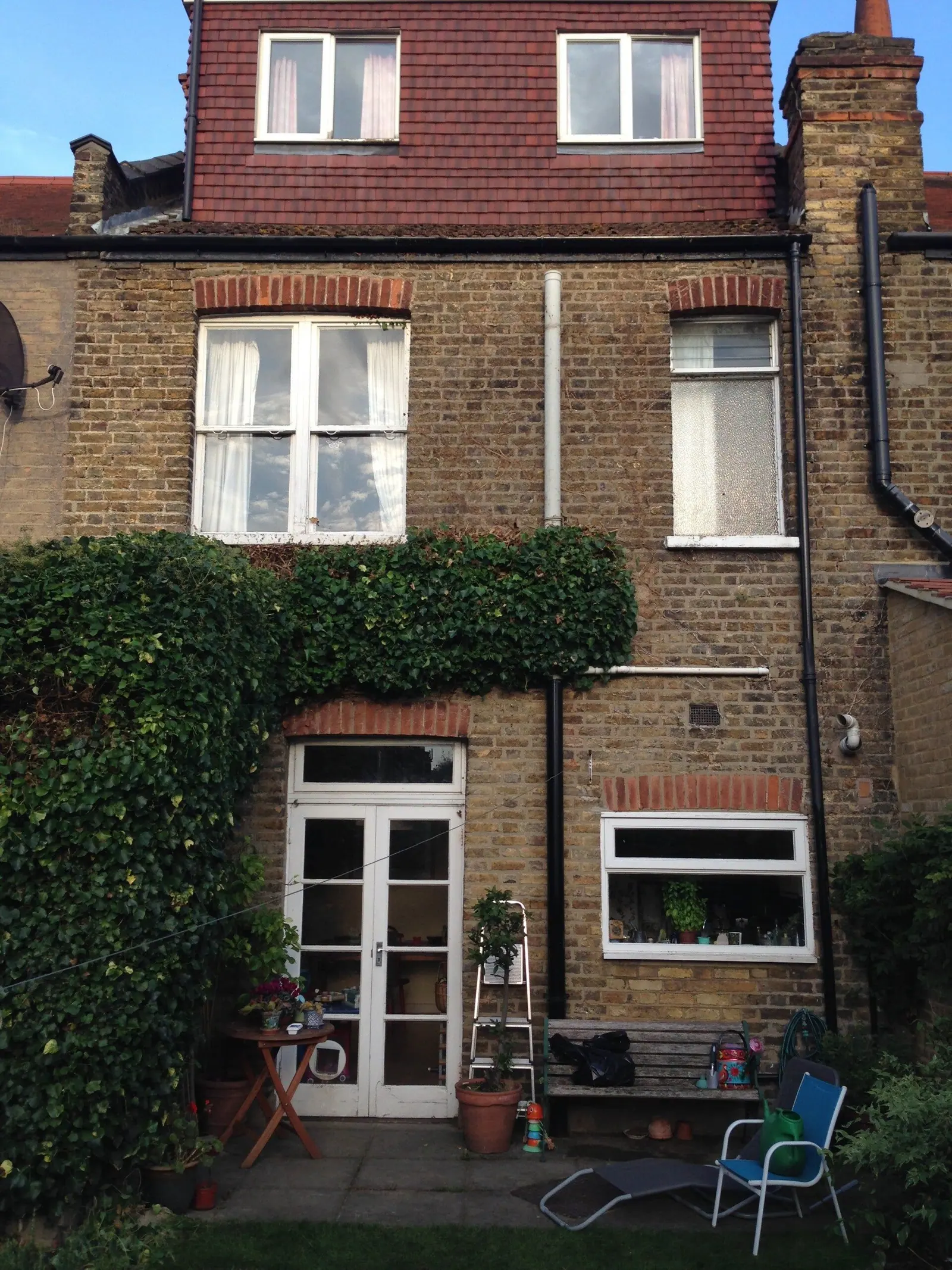 The same house front after the climber was trimmed clear of the windows
