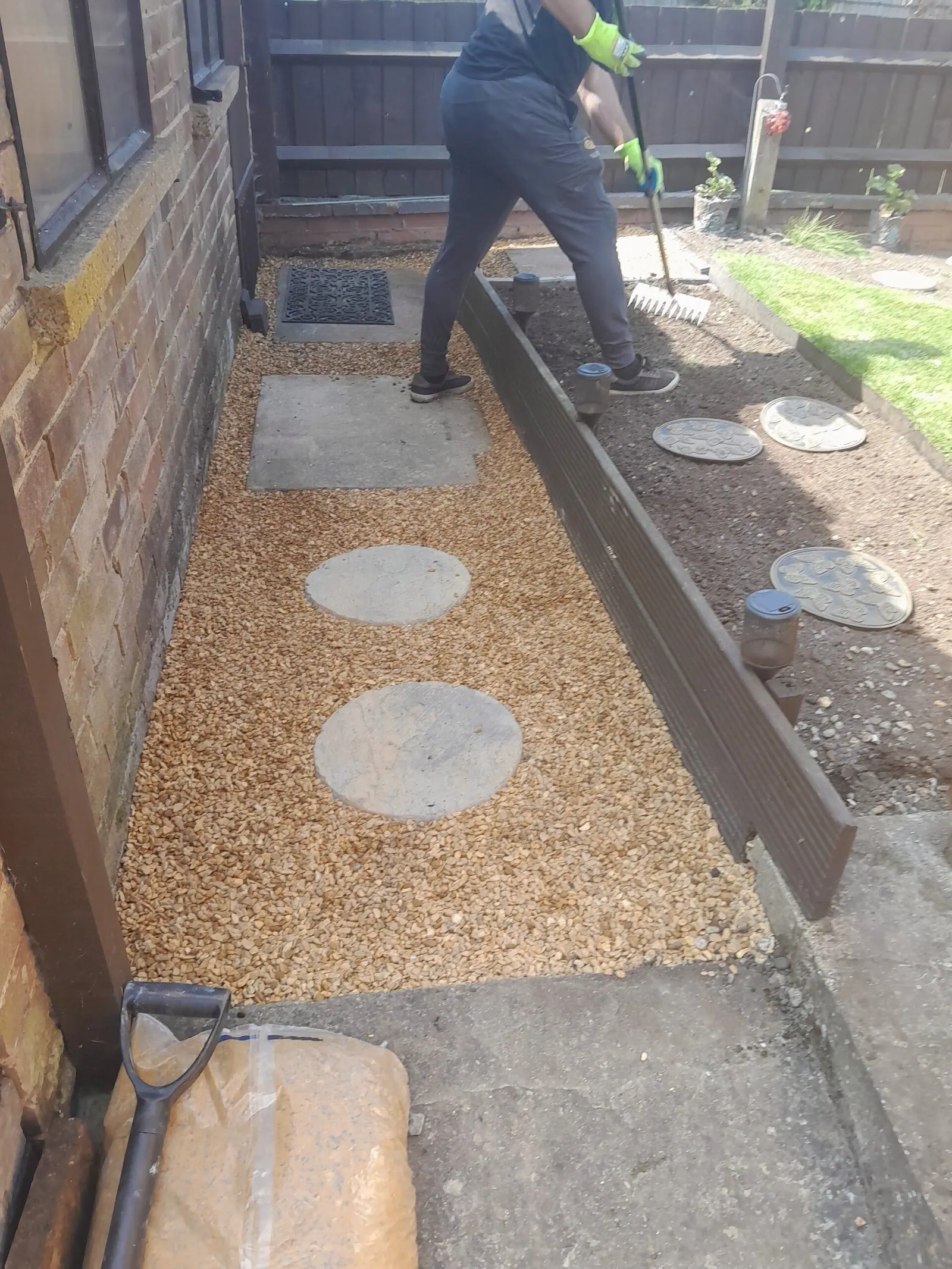 Gravel side path with round stepping stones between timber edging